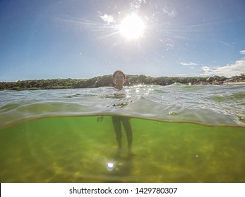 Half Underwater Shot Of Happy Smiling Boy. Child Boy In The Water On A Lake.