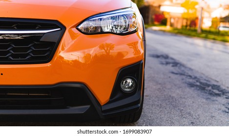 Half View Of A Bright Orange Car