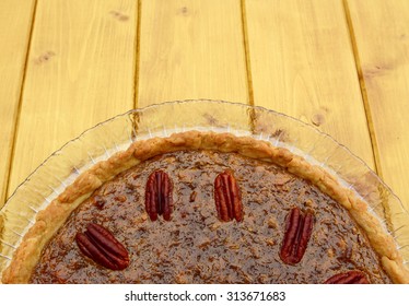 Half view of home-baked pecan pie, with copy space on wooden table