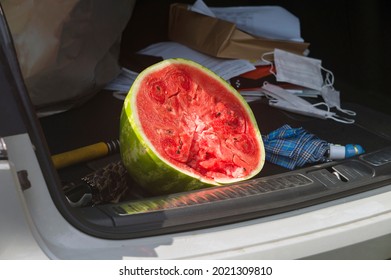 Half Of A Watermellon In A Messy Car Trunk, Outdoor Shot