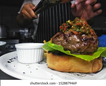 Half Way There, The Making Of A Burger, Exposed Meat And Chimichurri On The Bread. Gourmet Burger 