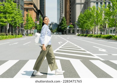 Half women crossing the crosswalk