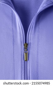 Half zipped cotton sweatshirt hoodie close-up. Fashionable summer blue violet jacket with zipper fastening. Casual outerwear and clothes in trendy color 2022 very peri. Zip fastener of pullover. Macro