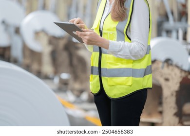 Half-body photo of European female engineer's determination to use laptop to improve machinery has impacted industry, setting new standards in efficiency and reliability. - Powered by Shutterstock