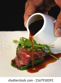 Half-cooked Lamb Meat With Arugula And Hand Pouring Gravy