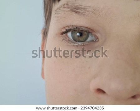 Half-face portrait of girl with emphasis on eye. Children vision