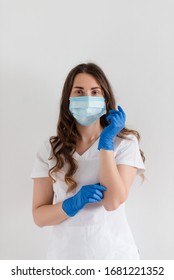 Half-growth portrait of serious nurse or doctor in medical mask and gloves on white background. Viral pandemic, covid-19. - Shutterstock ID 1681221352