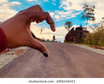 Half-hearted hands. The picture shows a beautiful sunset with the sky in the background and a person waiting with half his heart