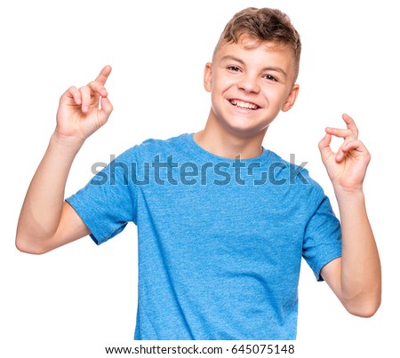 Half-length emotional portrait of caucasian teen boy wearing blue t-shirt. Smiling teenager looking at camera. Handsome happy child, isolated on white background.