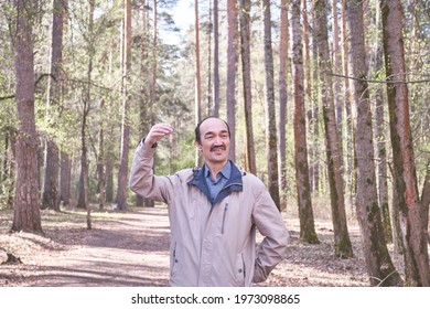 Half-length Portrait Of Senior Asian Man Reciting Poetry In Forest Park.