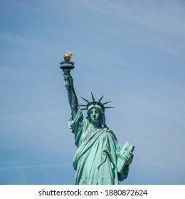 Half-length Portrait Of The Statue Of Liberty In Manhattan New York City, With Slightly Hazy Blue Sky