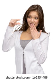 Half-length Portrait Of Woman Showing Small Amount Of Something And Covering Mouth With A Hand, Isolated On White