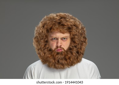 Half-length portrait of young very hairy man isolated over grey background. - Shutterstock ID 1914441043