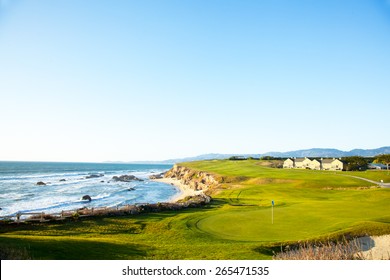 Halfmoon Bay California.  Golf course putting green and cliffs by the pacific ocean bay.  Villas and houses.