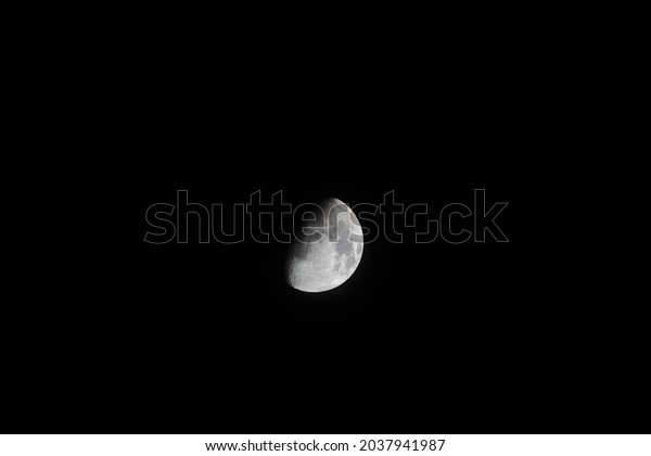 The half-moon in\
the black sky  Moon phases 