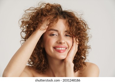 Half-naked Ginger Woman Smiling And Holding Her Head Isolated Over White Background