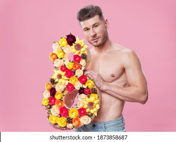 Half-naked Guy With Number From Flowers Decoration Pink Background