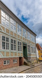 Half-timbered House With Big Windows In The Facade With Reflections Of The Blue Sky, Haderslev, Denmark, August 26, 2021