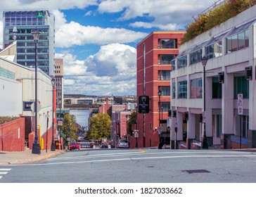 Halifax, Nova Scotia, Canada - October 4, 2020 : Looking down the hilly Carmichael Street from Brunswick Street. Across the harbor can be seen Nova Scotia Community College's Ivany Campus building.


