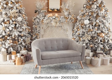 Hall Room Interior With A Couch, Fireplace With Candles And Decorated Christmas Tree With Gifts. Large Designer Snow Tree In Lounge With Lights And Balls In Beige, Brown, Gold And Silver Colors.