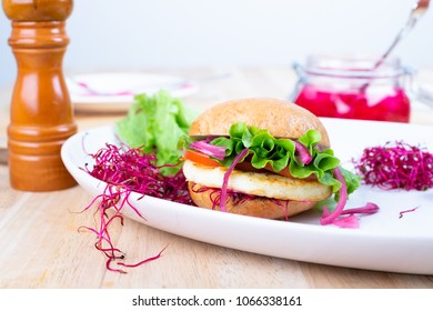 Halloumi burger with lettuce, tomato, pickled red onion and beet sprouts.