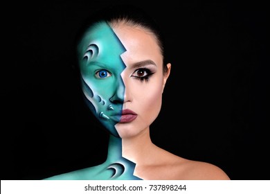 Halloween alien makeup. Close up portrait of half face alian and half face of young woman