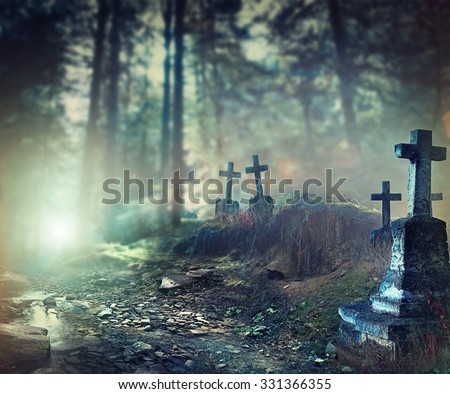 Halloween art design background. Foggy Graveyard at night. Old Spooky cemetery in moonlight through the trees