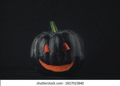 Halloween Background Of Black Painted Pumpkin On Black Background