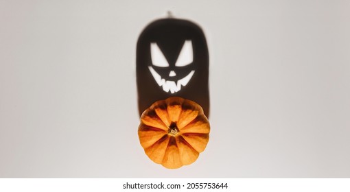 Halloween Background Concept. Jack O Pumpkin Angry Face Shadow. Spooky Smiling Shadow Of An Orange Pumpkin Lantern Top View Close Up, Halloween Party Design