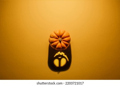Halloween background concept. Jack O pumpkin angry face shadow. Spooky smiling shadow of an orange pumpkin lantern top view close up, Halloween party design - Shutterstock ID 2203721017
