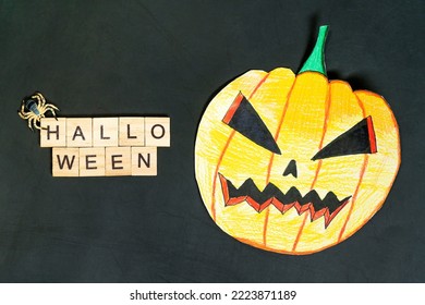 Halloween Background Design. Halloween Text On Wooden Blocks And Painted Pumpkin On Black Background.