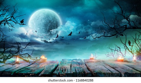Halloween Background  - Old Table With Candles And Branches At Spooky Night With Full Moon
