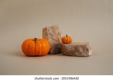 Halloween background podium display with pumpkins on biege background. Cosmetic, beauty product promotion autumn pedestal
