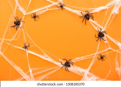 Halloween background with spider web and spiders as symbols of Halloween on the orange background. Happy Halloween concept. Frame - Powered by Shutterstock