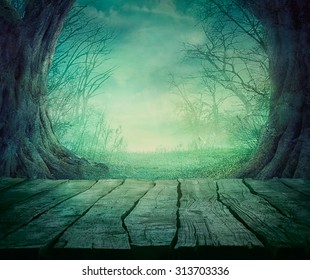 Halloween Background. Spooky Forest With Dead Trees And Wooden Table. Wood Table
