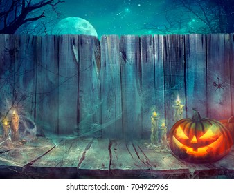 Halloween background. Spooky pumpkin on table. Halloween design with pumpkins and skull