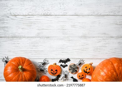 Halloween background, top view. Pumpkins and sweets on white wooden table, flat lay. Hallowen food and decorations on wood planks with space. Design, fall, October, Halloween, treat and trick concept - Shutterstock ID 2197775887