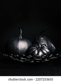 Halloween Black Pumpkins On A Dark Background. Creepy Holiday Decor. Painted Pumpkin. Copy Space.