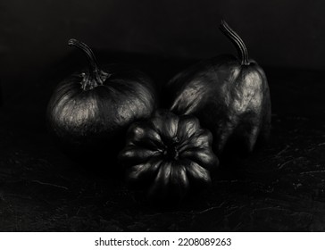 Halloween Black Pumpkins On A Dark Background. Creepy Holiday Decor. Painted Pumpkin. Copy Space.