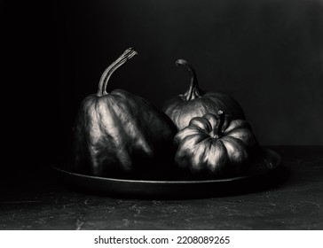 Halloween Black Pumpkins On A Dark Background. Creepy Holiday Decor. Painted Pumpkin. Copy Space.