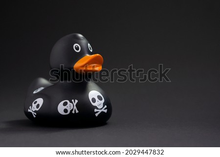 Halloween black rubber duck on dark background with copy space .Cleaning  service advertising concept.Halloween post card .