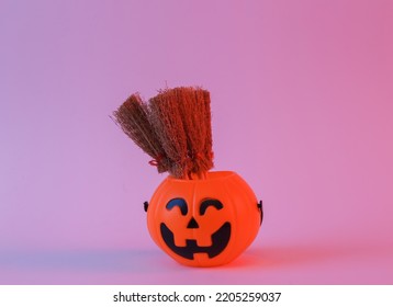 Halloween bucket with witch brooms in neon light - Powered by Shutterstock