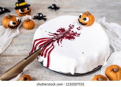 Halloween Cake Splattered With Fake Blood And Decorated With Sugar Paste; Pumpkins That Laugh