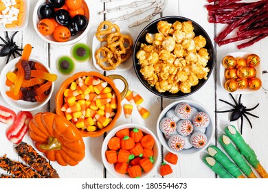 Halloween candy buffet table scene over a white wood background. Selection of fun, spooky treats. Top view. - Powered by Shutterstock