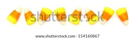 Halloween candy corn border over white background                       