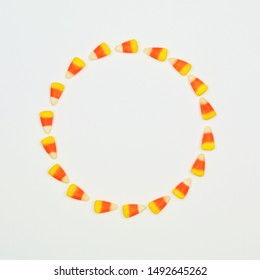 Halloween Candy Corn Circle Frame. Top View On A White Background With Copy Space.