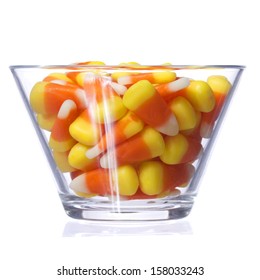 Halloween Candy Corn In Glass Bowl Isolated On White Background. Closeup