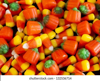 Halloween Candy Corn And Pumpkin Candies On Black Background.