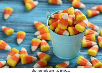 Halloween Candy Corns In Bucket On Blue Wooden Background