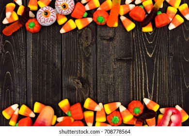 Halloween candy double border over a dark black wood background